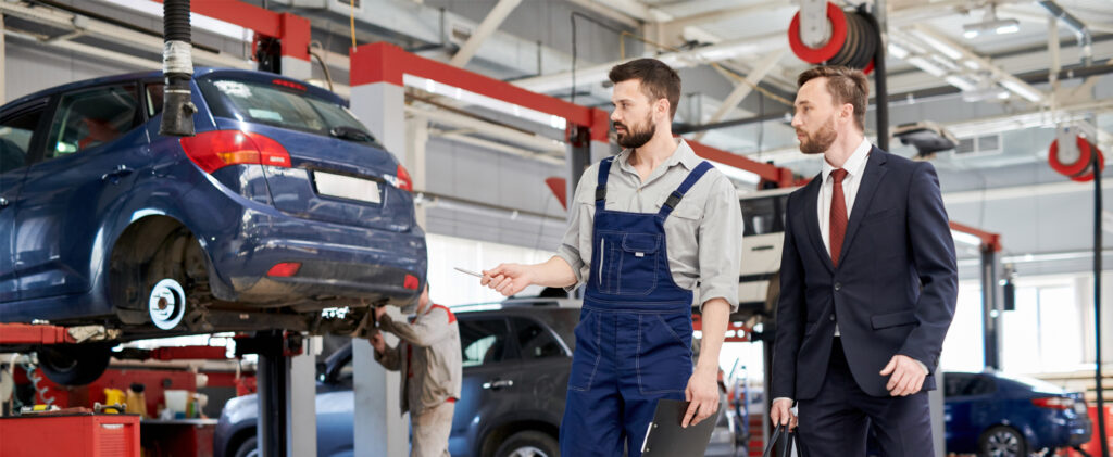 Auto worker giving tour to investor